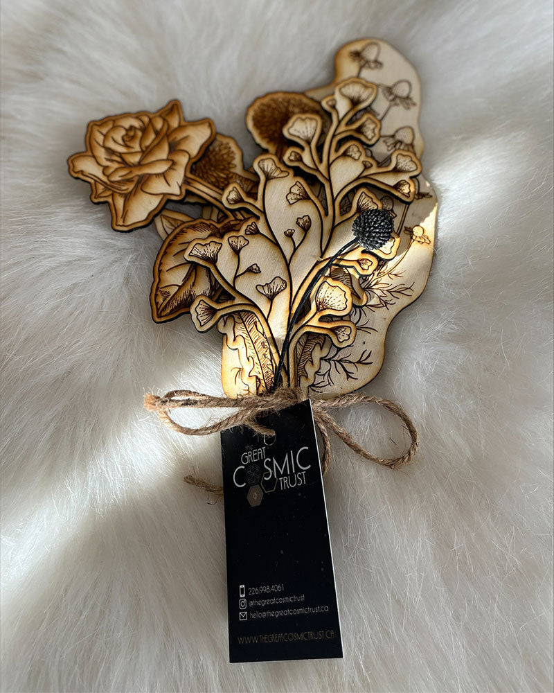 A bouquet of four laser cut fir and one black dried flower that will last forever